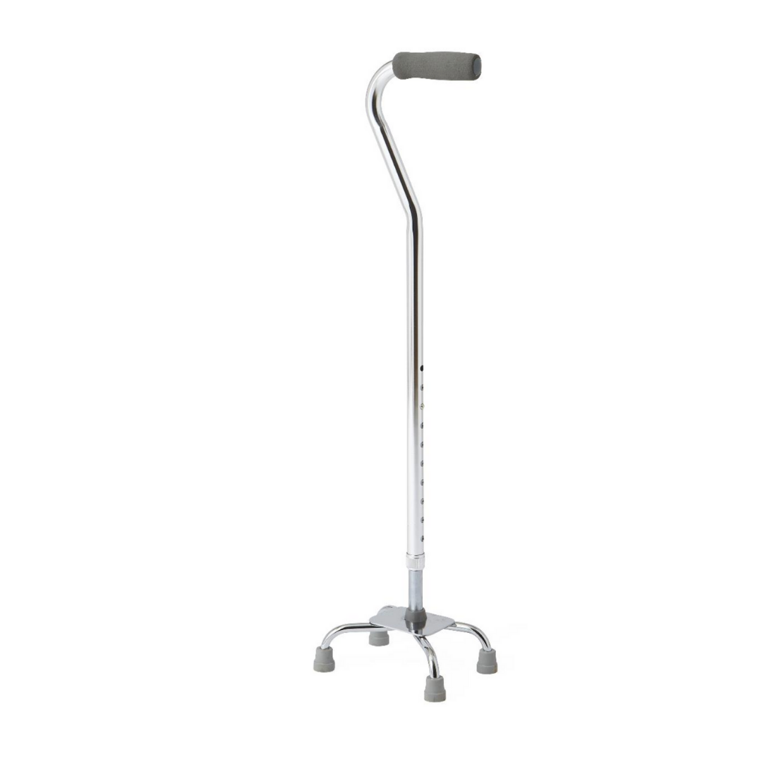 The Medline Quad Canes with Small Base feature a silver frame, gray foam handle, and four skid-resistant rubber tips for stable, reliable support. The cane stands upright on a white background.